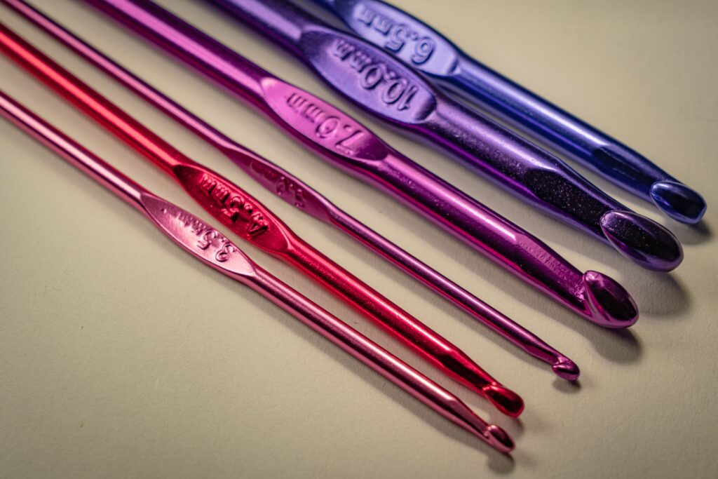 pexels-photo-3639038-3639038 Vibrant set of crochet hooks in multiple colors on a light background.