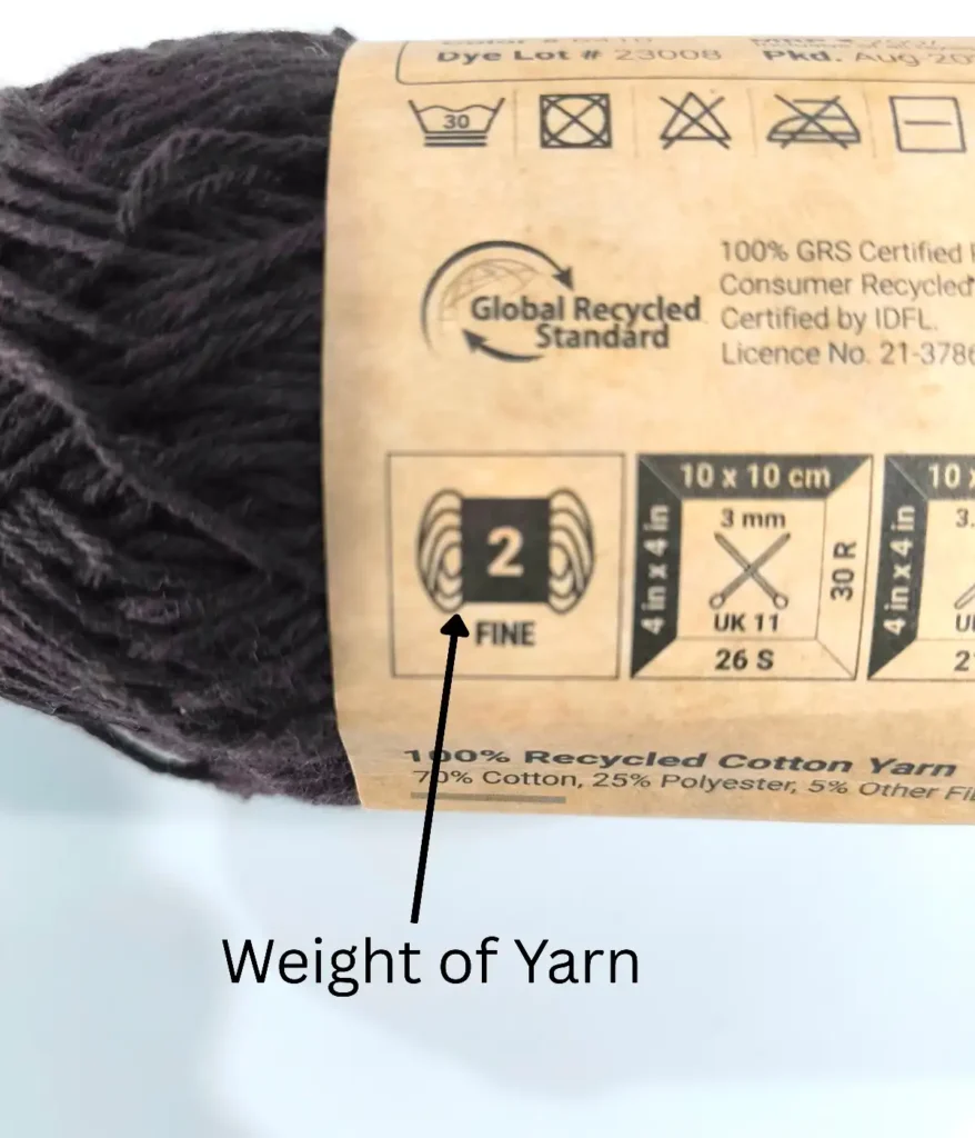 A coffee color yarn skein showing weight number of yarn explaining with written text.