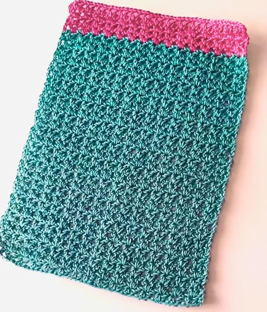 A green colour crochet placemat made by v stitch placed on white background